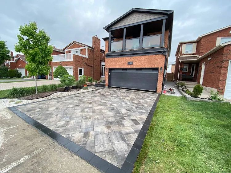 A wide-angle shot of a newly installed driveway with interlocking pavers.